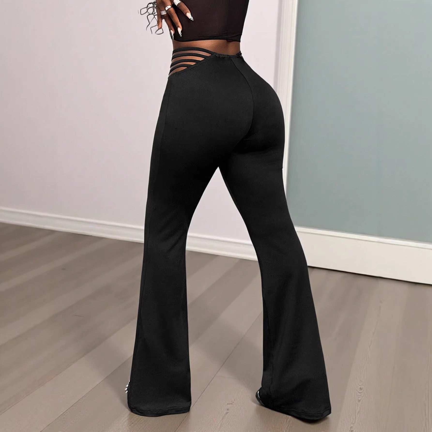 Black high-waist flared active pants with tummy-control and butt-lifting features by Flip Styles, shown on a model.